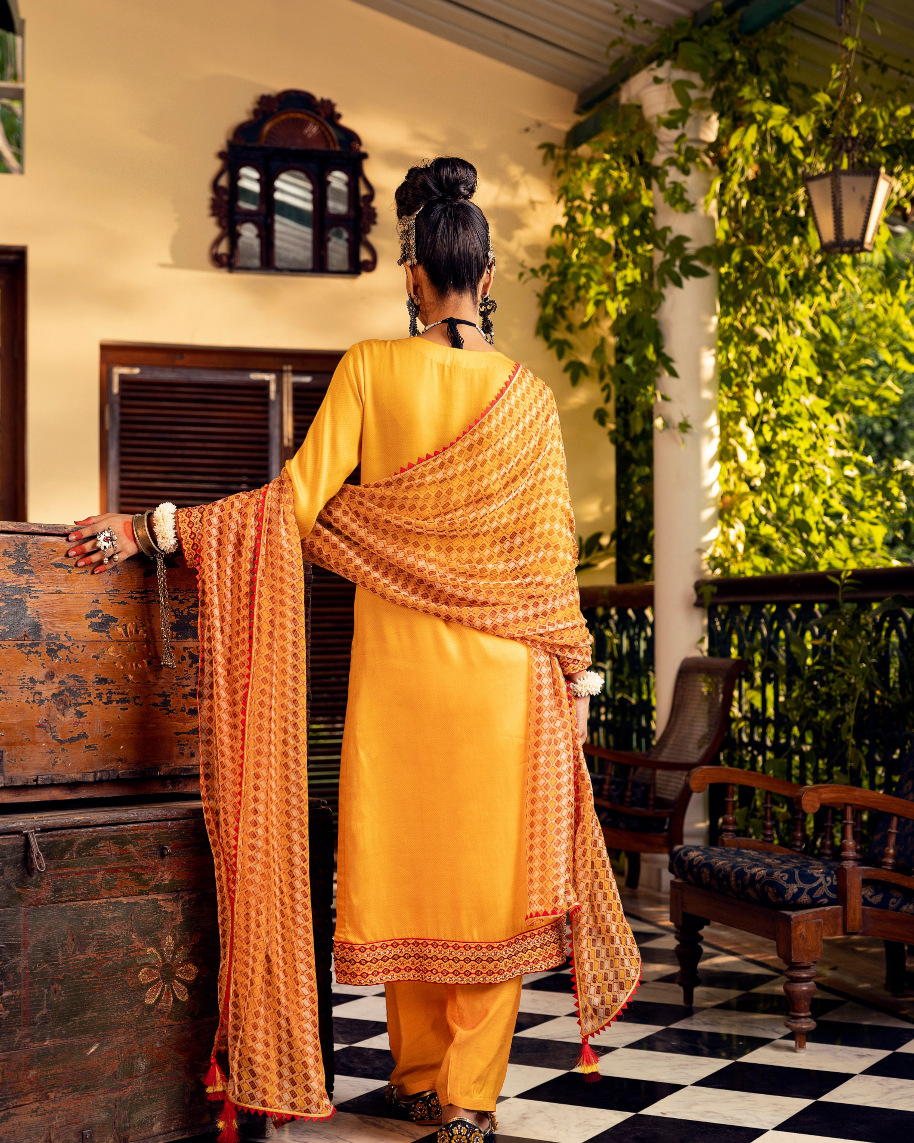 Yellow printed kurta in satin base with embroidery with pants Backview