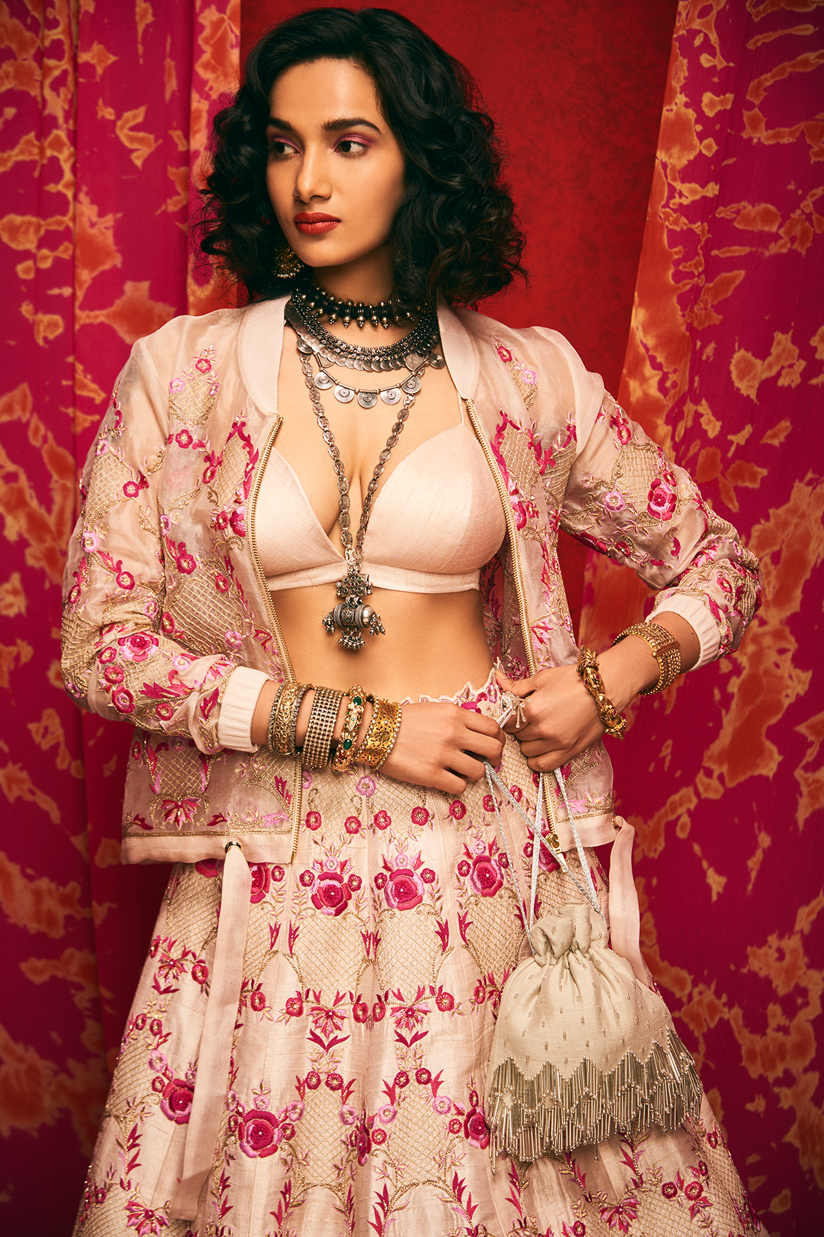 Pale pink raw silk lehenga set with a bralette and an organza bomber jacket.
