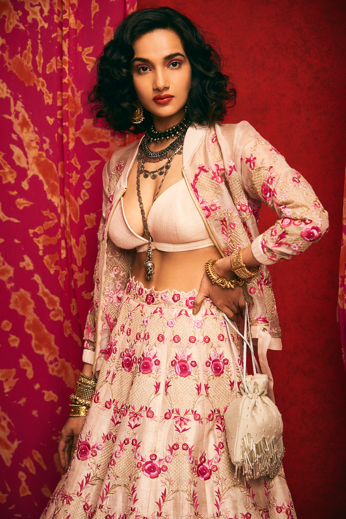 Pale pink raw silk lehenga set with a bralette and an organza bomber jacket.