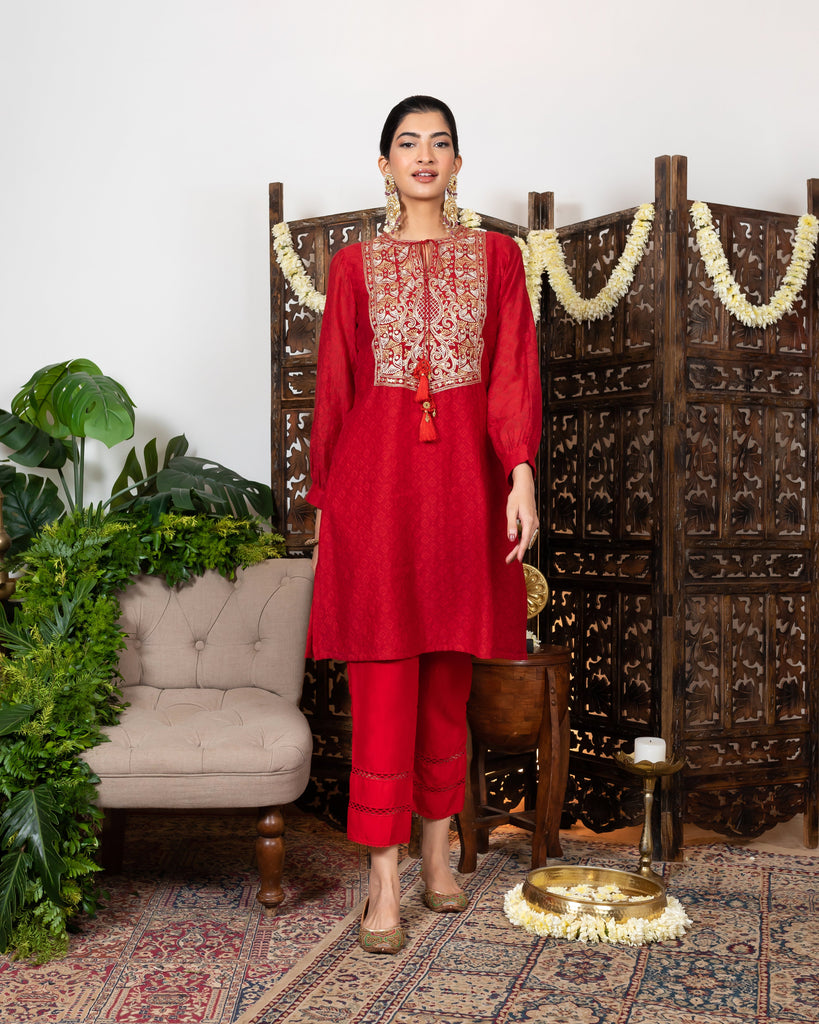 Red knee length kurta with embroidered yoke and tassles tie-up frontview