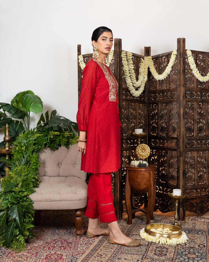 Red knee length kurta with embroidered yoke and tassles tie-up