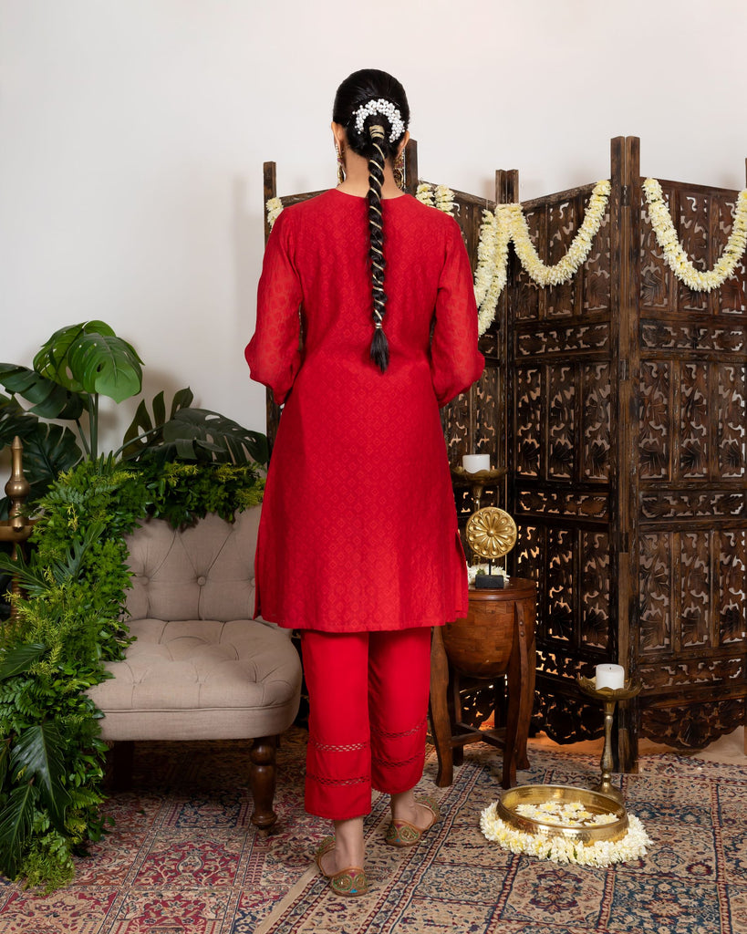 Red knee length kurta with embroidered yoke and tassles tie-up backview