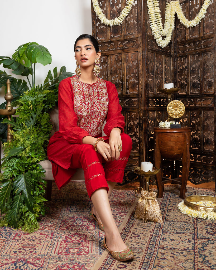 Red knee length kurta with embroidered yoke and tassles tie-up