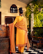 Yellow printed kurta in satin base with embroidery with  pants  Backview
