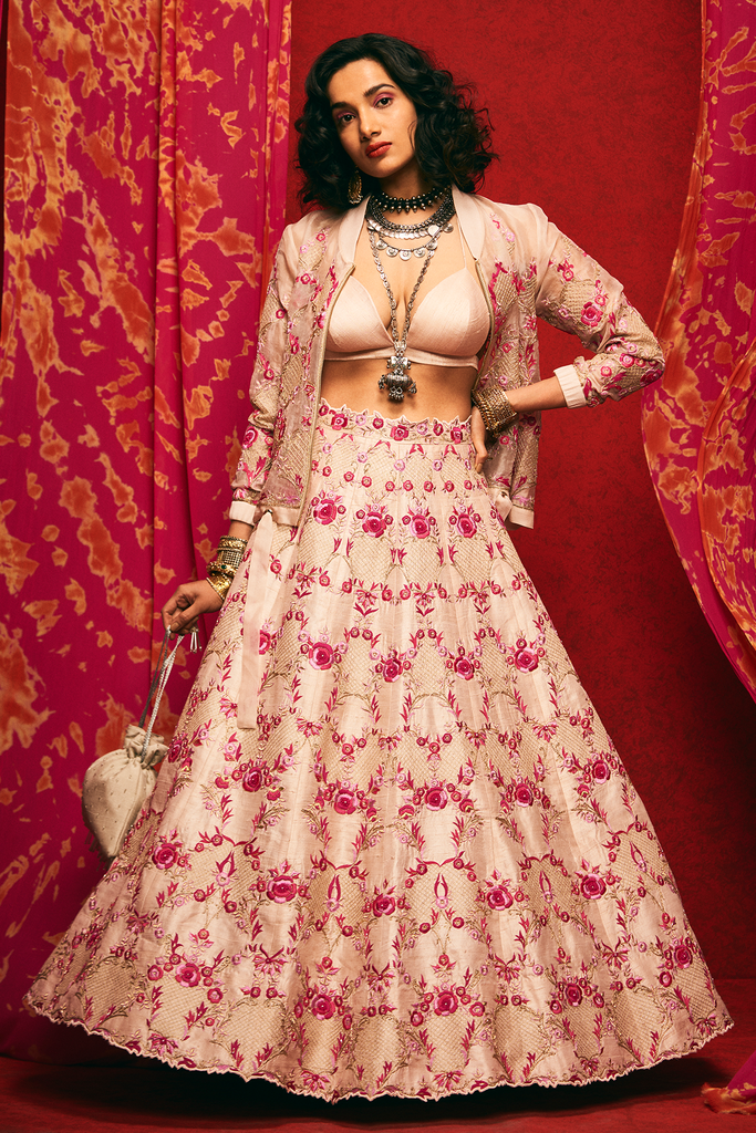 Pale pink raw silk lehenga set with a bralette and an organza bomber jacket.